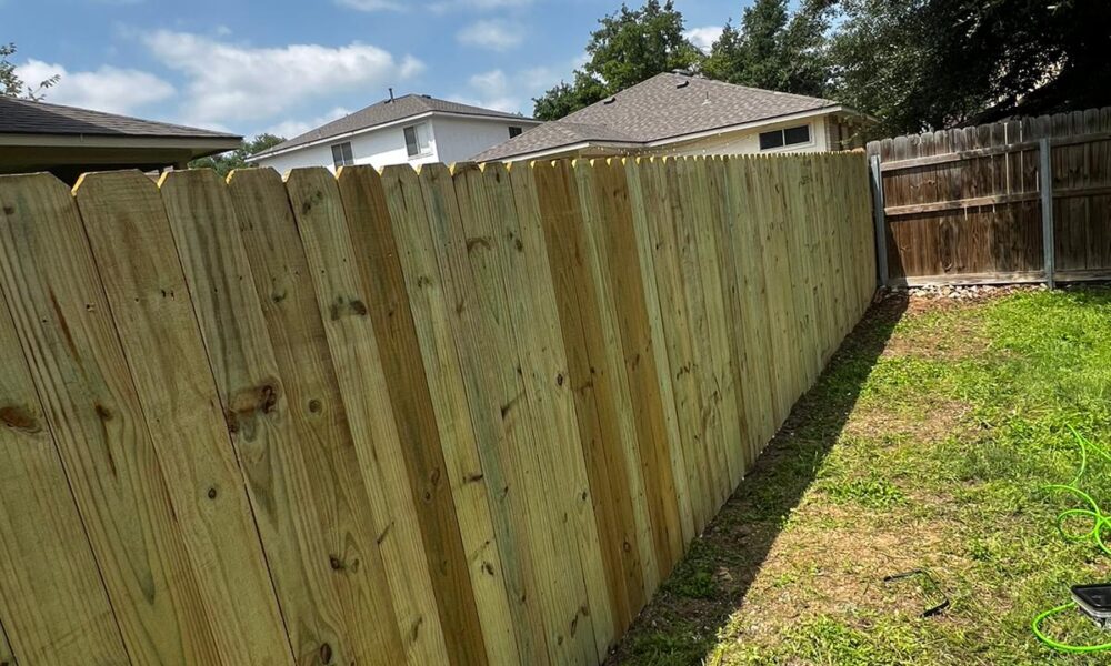 Close-up of pressure-treated wood privacy fence installed by a fence contractor in Central Texas