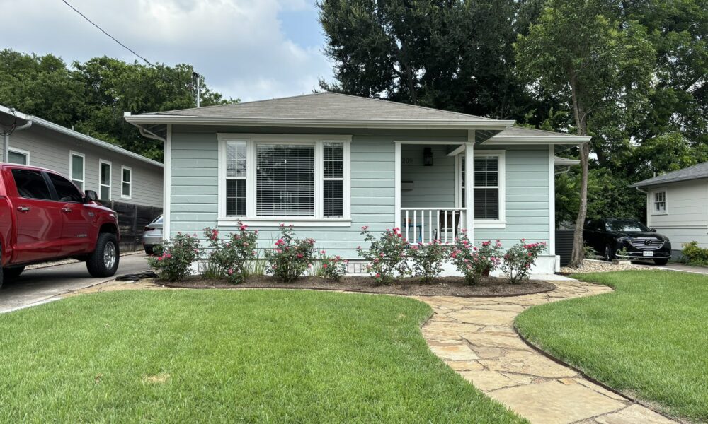 Soft wash power washing services cleaning the siding of a residential home to remove mildew