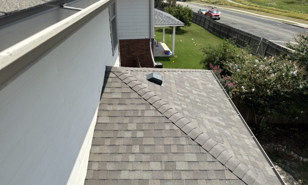 Close-up of newly installed downspout directing water away from the Hutto home's foundation